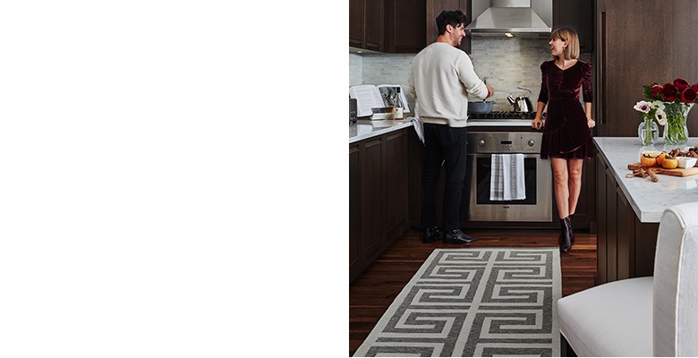 The kitchen is open to the rest of the home, so every detail had to be both beautiful and functional. The Perennials Greek Key rug is designed for indoor and outdoor use, perfect for the kitchen of dog-owners since it is durable and can be easily wiped clean. “The overscale Greek key pattern in the kitchen rug makes a narrow space look bigger,” notes Lainey. The overall effect is a space that’s luxurious yet livable, perfect for a stylish couple like Jenny and Freddie.