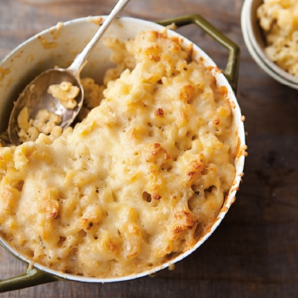 An olive-green saucepan filled with sumptuous truffle mac and cheese. 