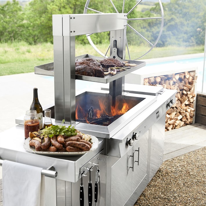 https://assets.wsimgs.com/wsimgs/ab/images/dp/wcm/202340/0115/kalamazoo-gaucho-wood-fired-freestanding-grill-with-side-b-o.jpg