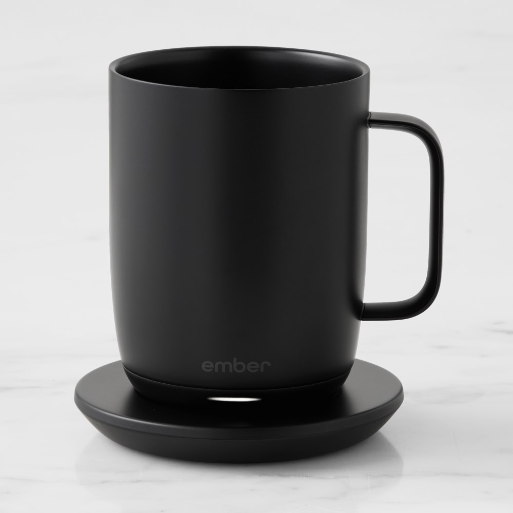 A black mug on a warming plate