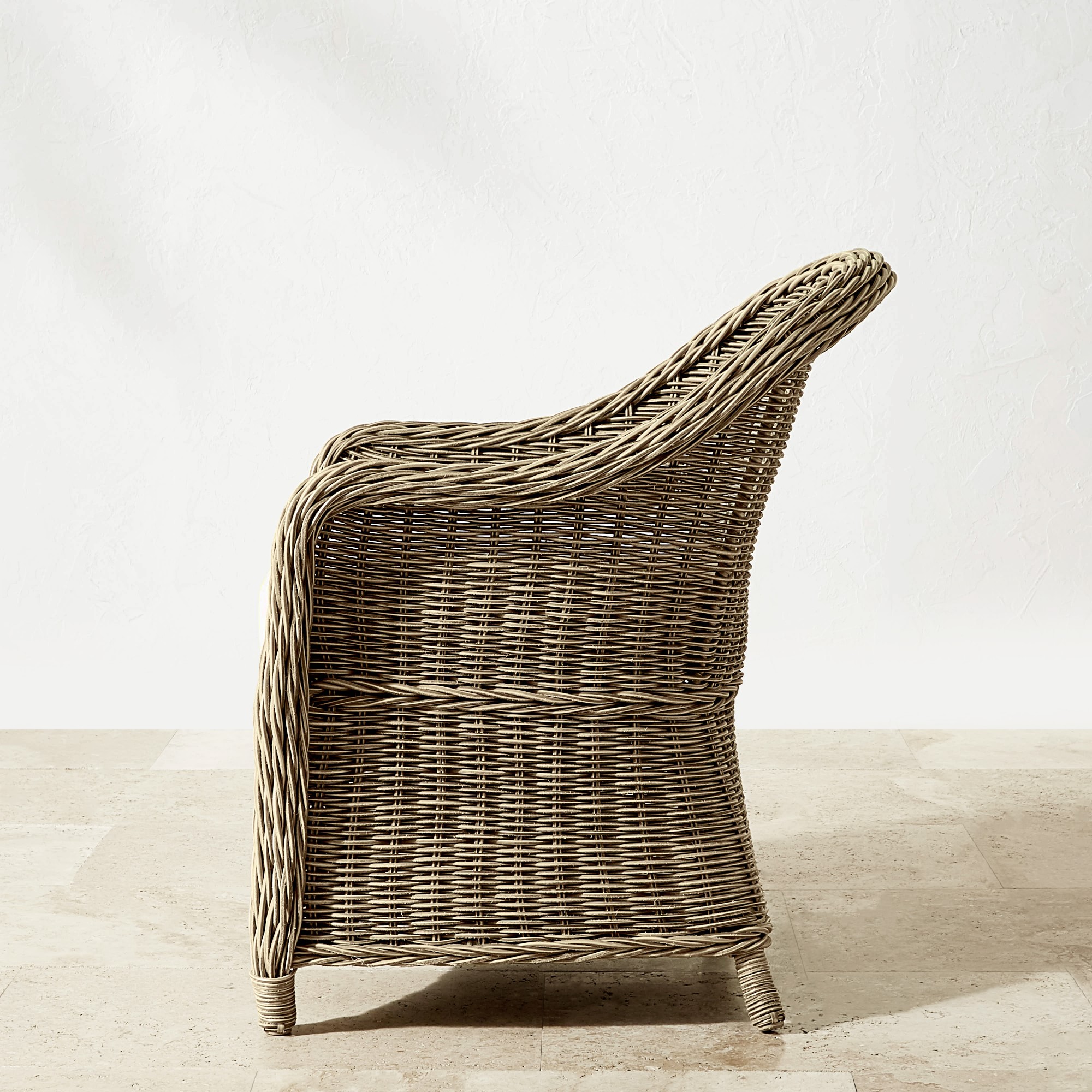 Back view of a brown wicker chair showing woven texture