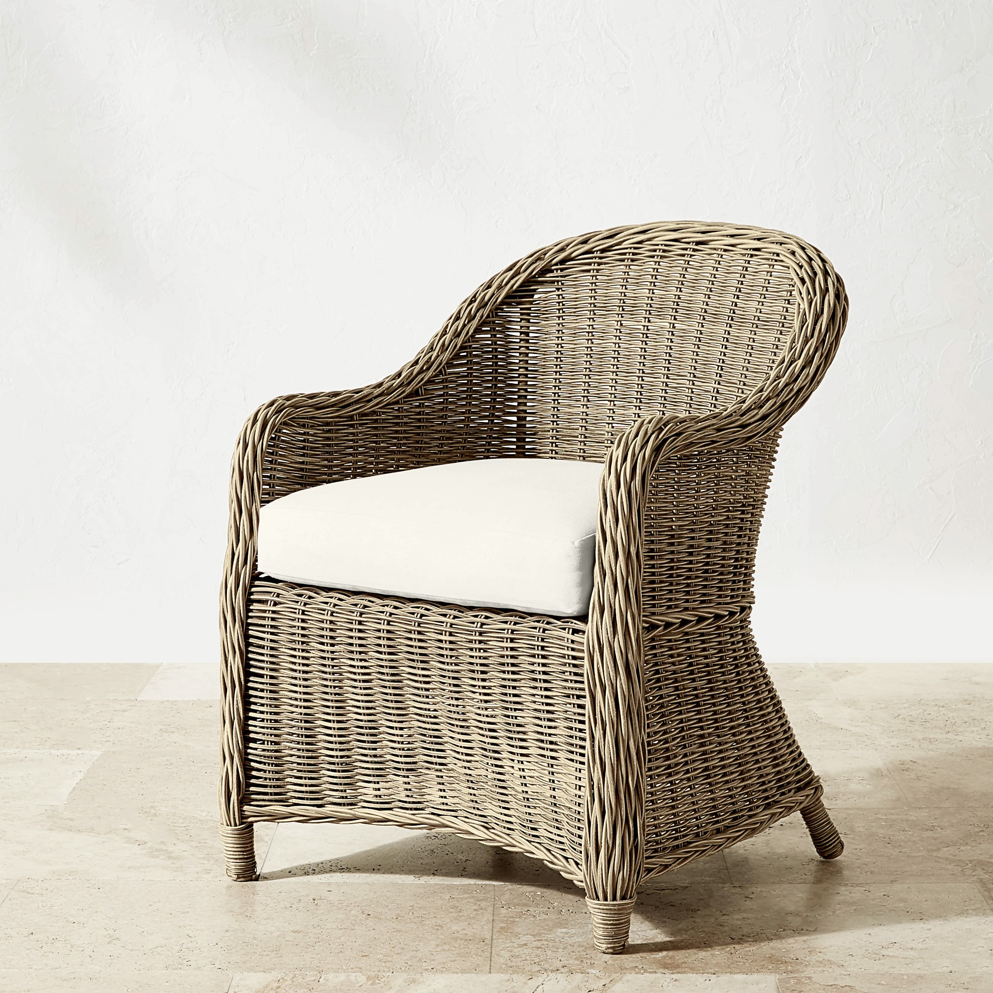 Close-up of wicker chair, side view, showing weave and seat