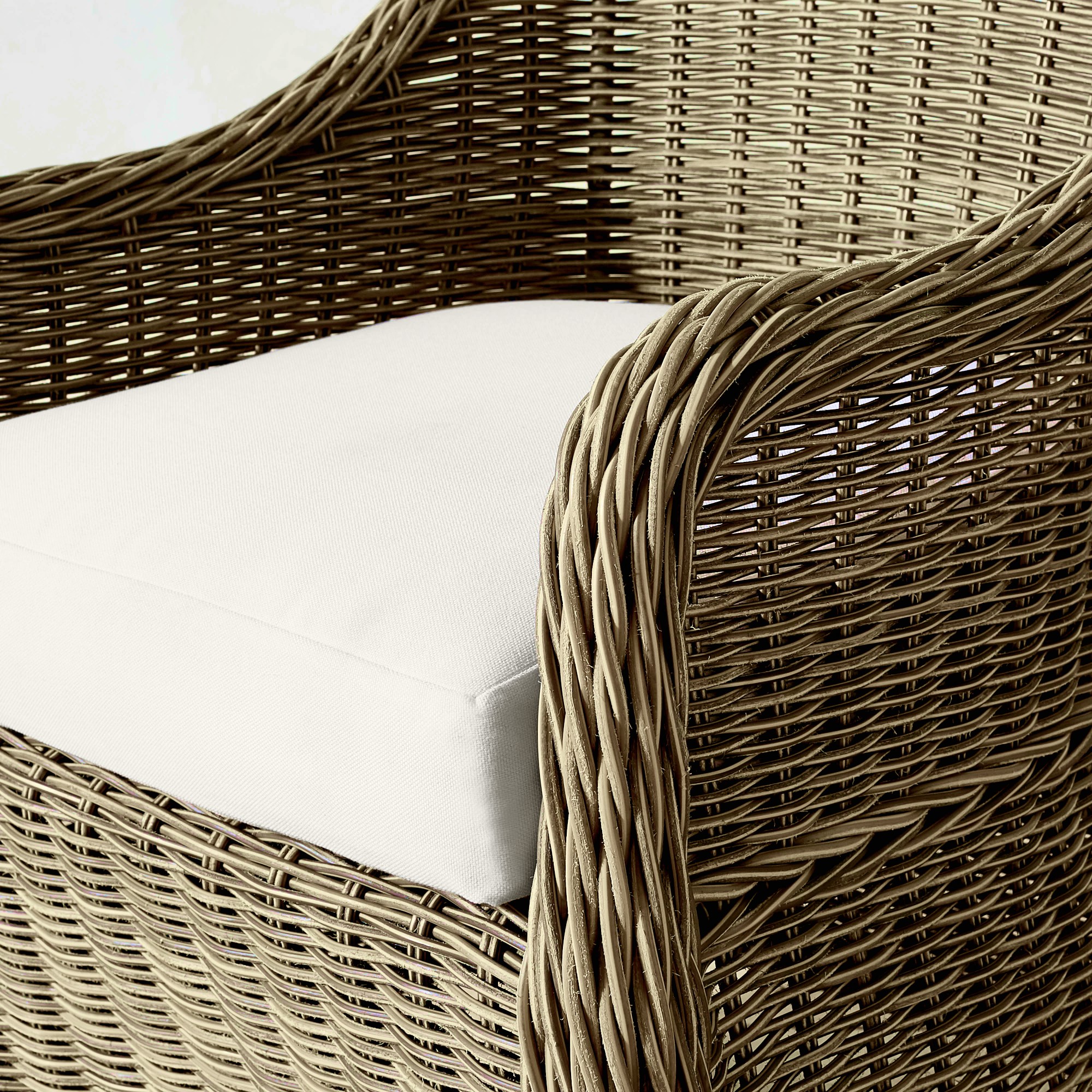 Close-up of the cushion and wicker arm of the chair
