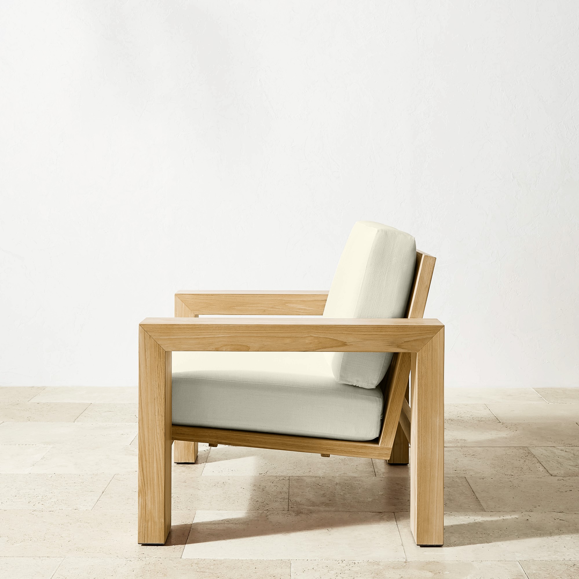 Back view of wooden armchair with off-white cushion