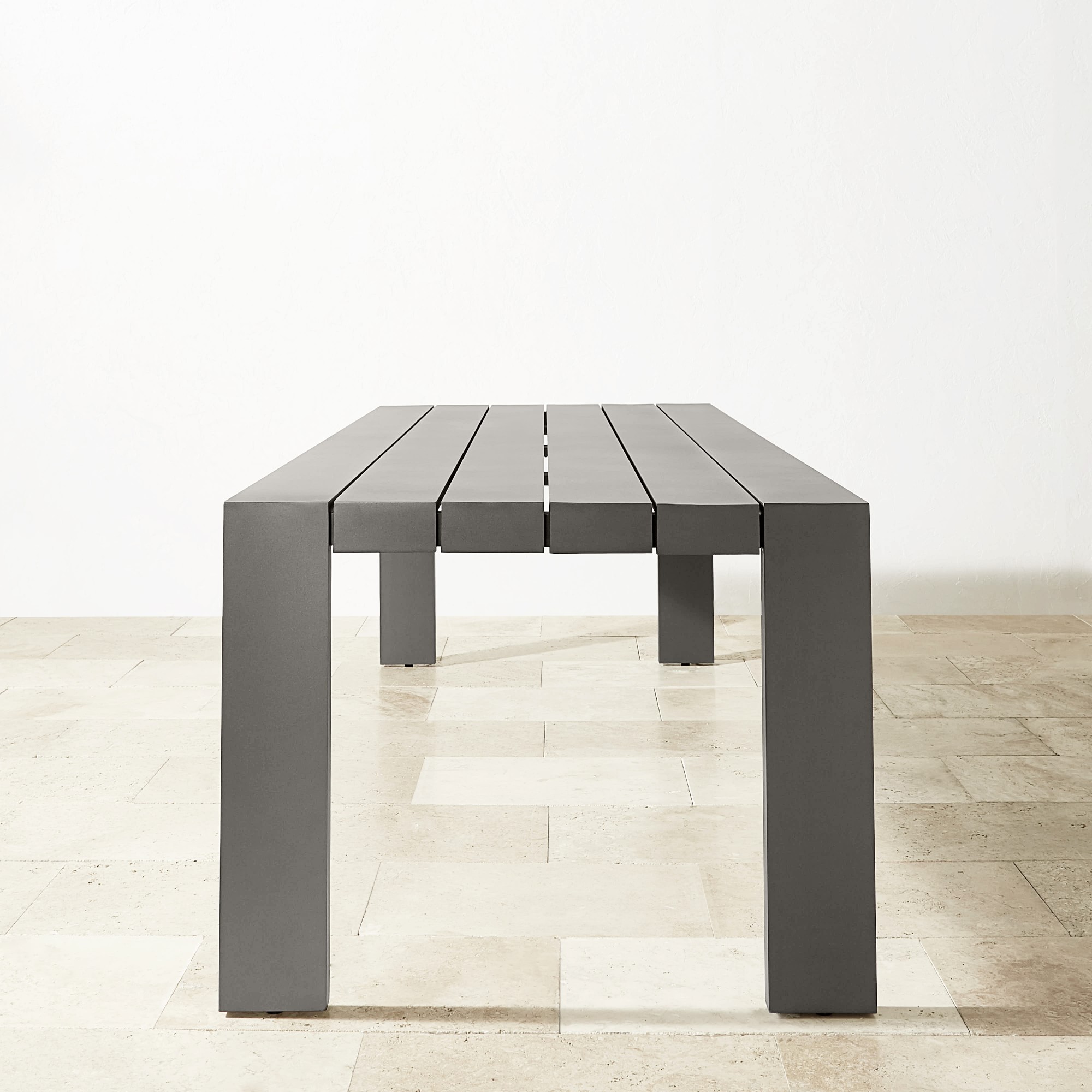A long gray table with two large legs and a split center design.