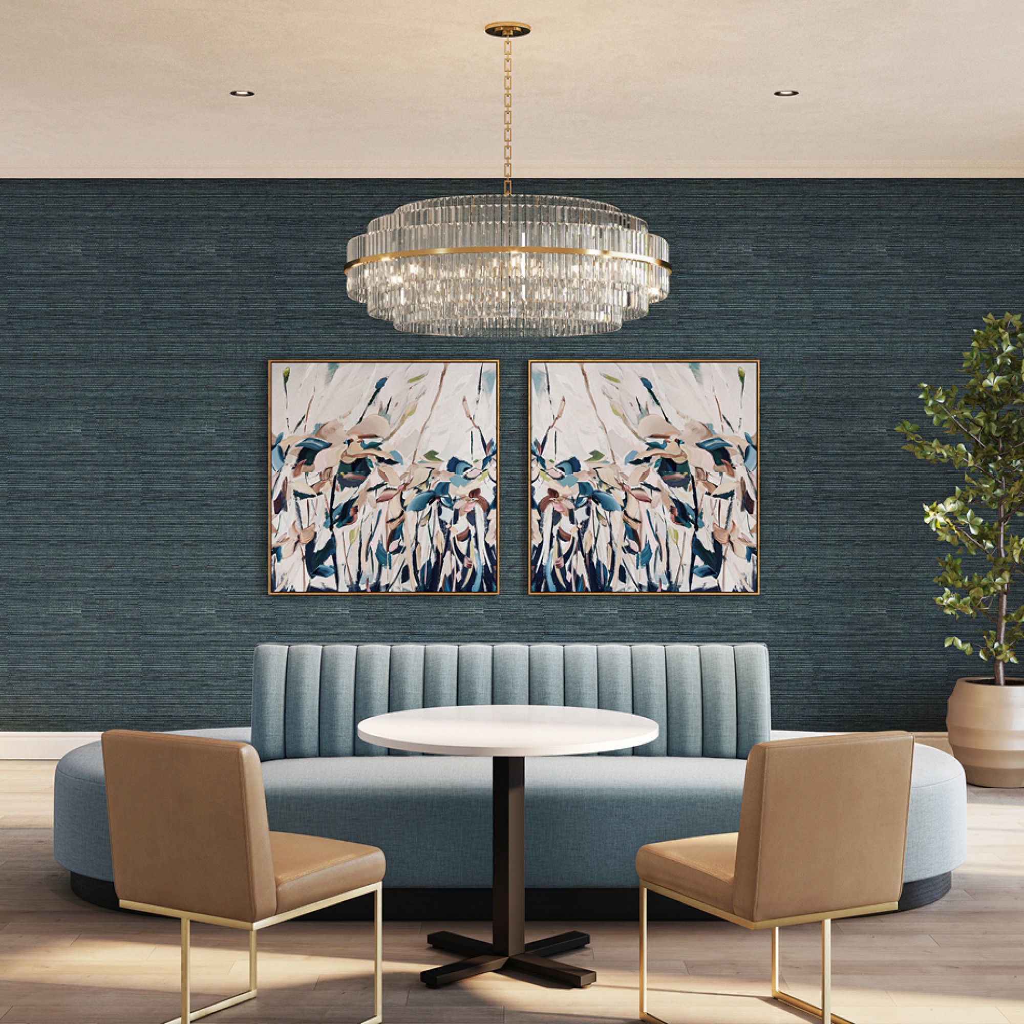 Chandelier above a booth seating area with framed art on a blue wall.