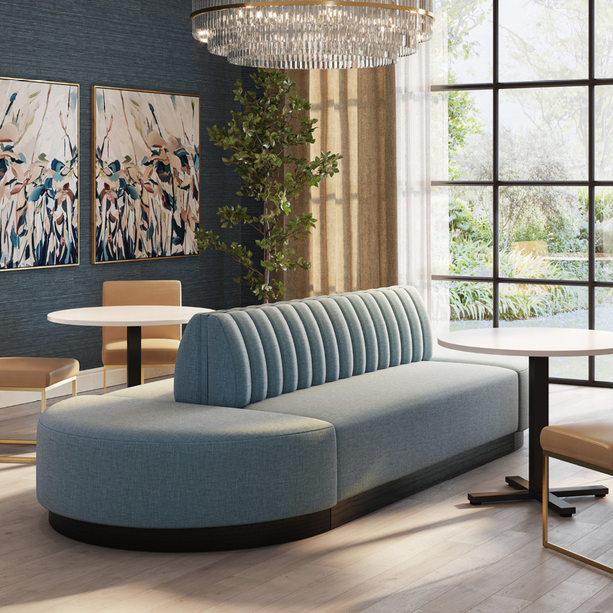 A modern living room with blue upholstered booth, two round white tables, chairs, and a fireplace.