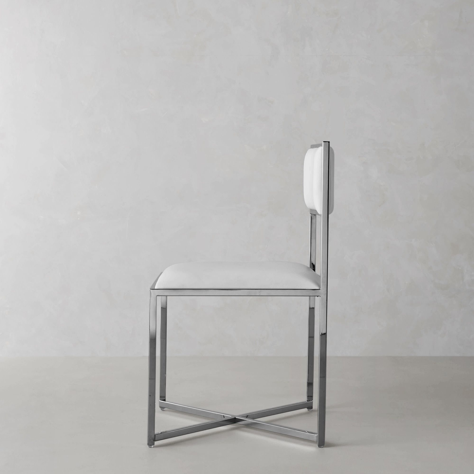 Side view of a white upholstered bar/side chair with a chrome frame set against a gray background.