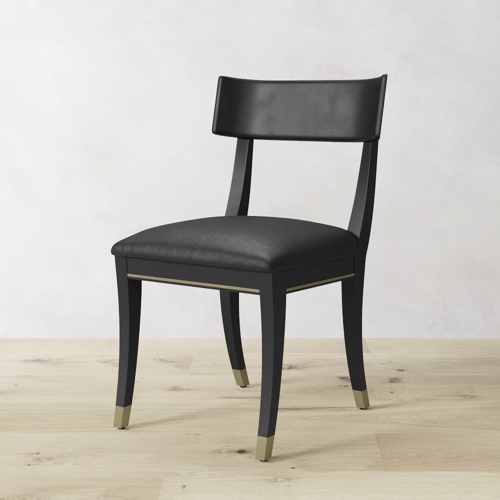 Klismos chair side view showing gold-tone accent