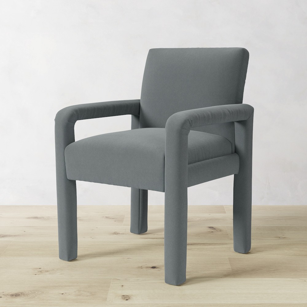 Grey upholstered dining chair front-left angle