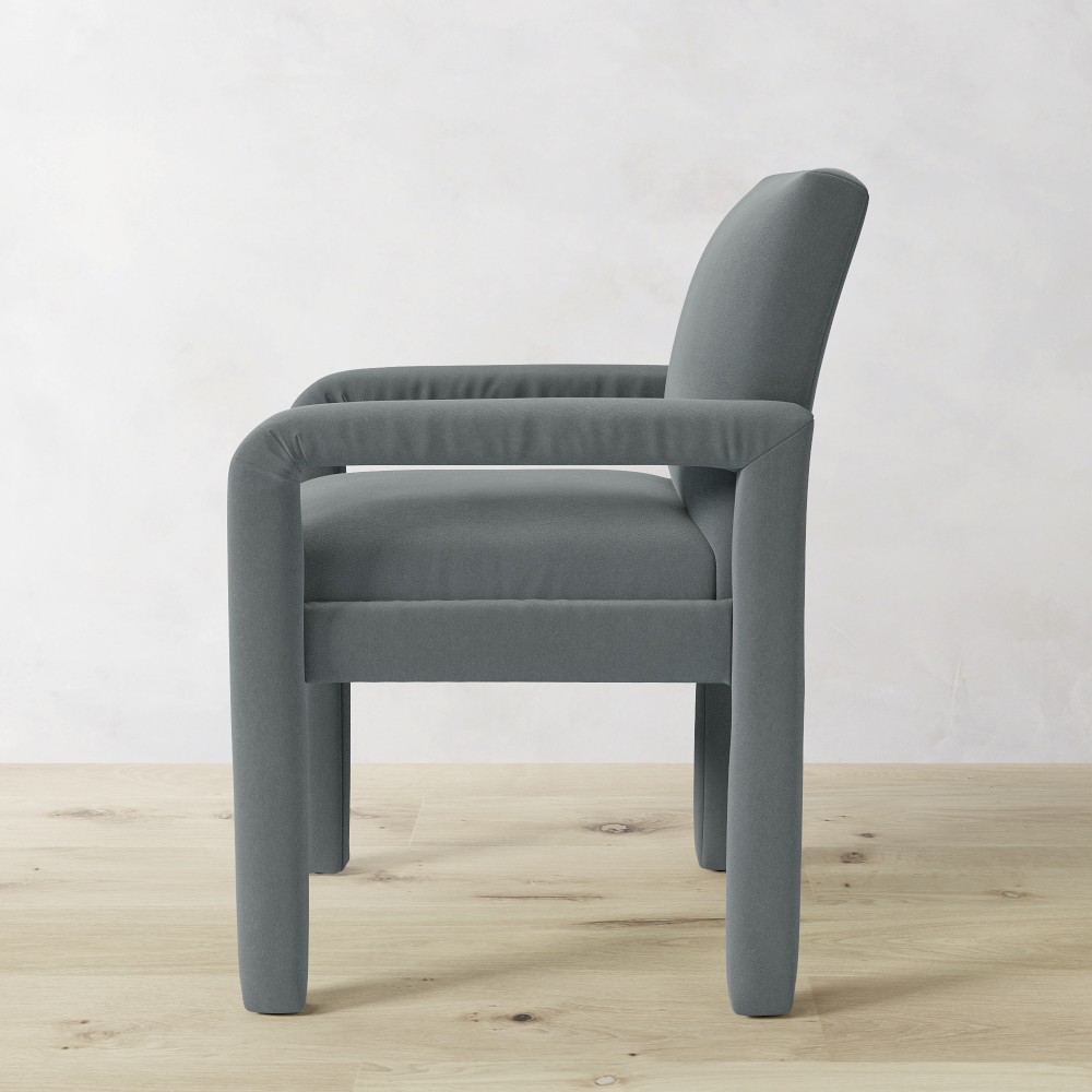 Grey upholstered dining chair side view