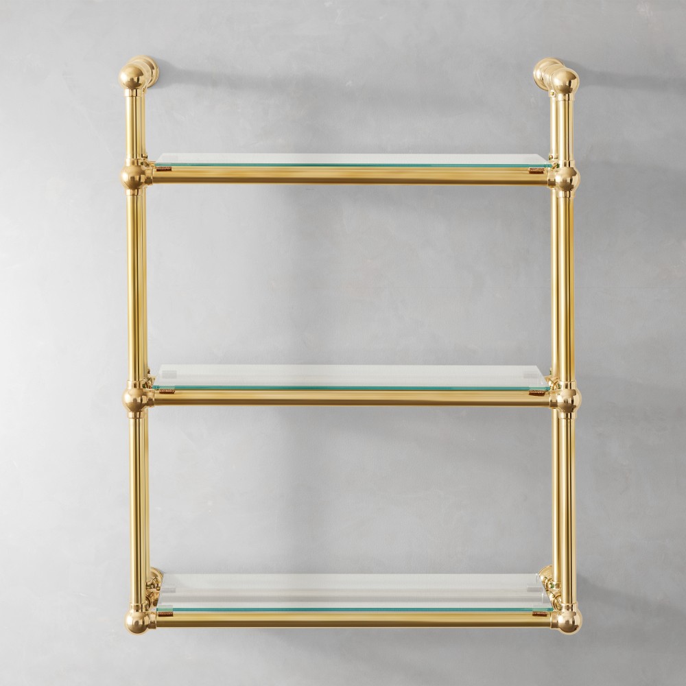 Brass wall shelf with two glass shelves mounted on wall