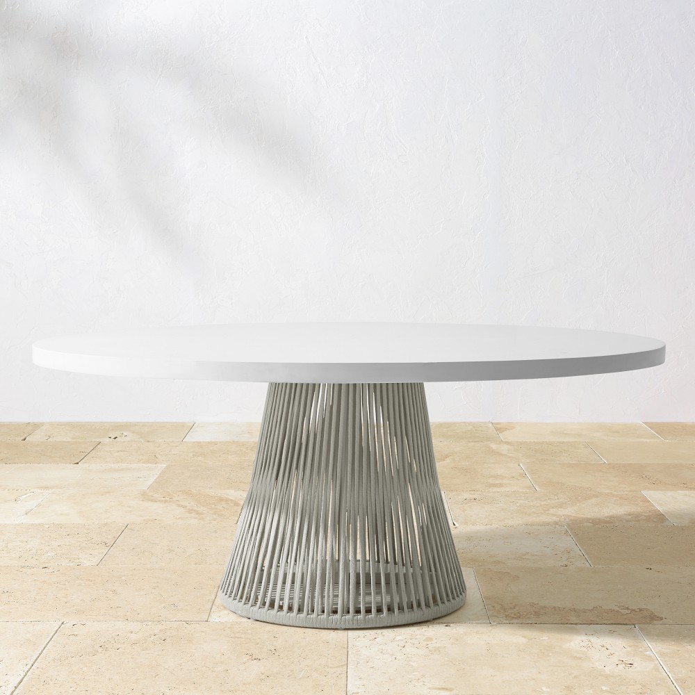 Side view of the white oval tabletop on ribbed pedestal base