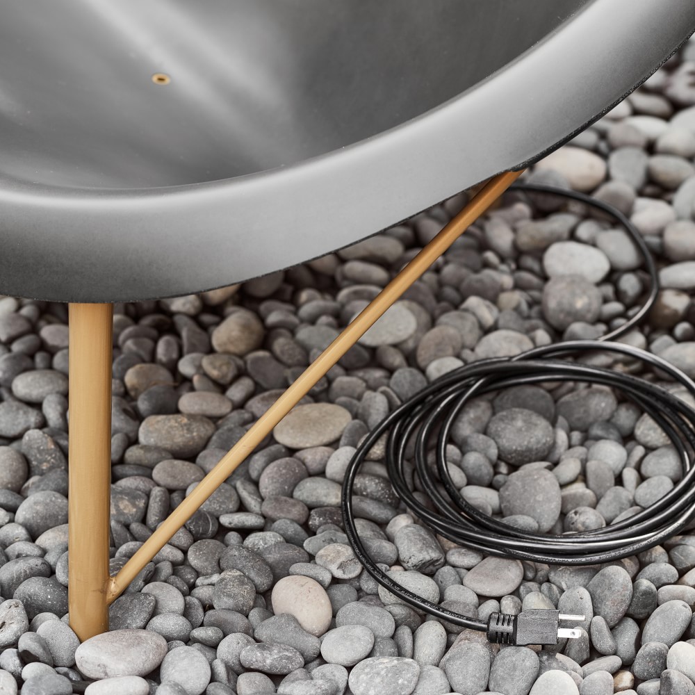 Electrical cord coiled next to the bench leg