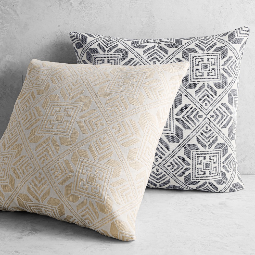 Beige and dark grey geometric patterned outdoor pillows, pair on light surface