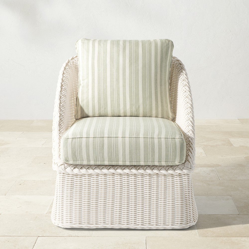 White wicker armchair with striped back cushion