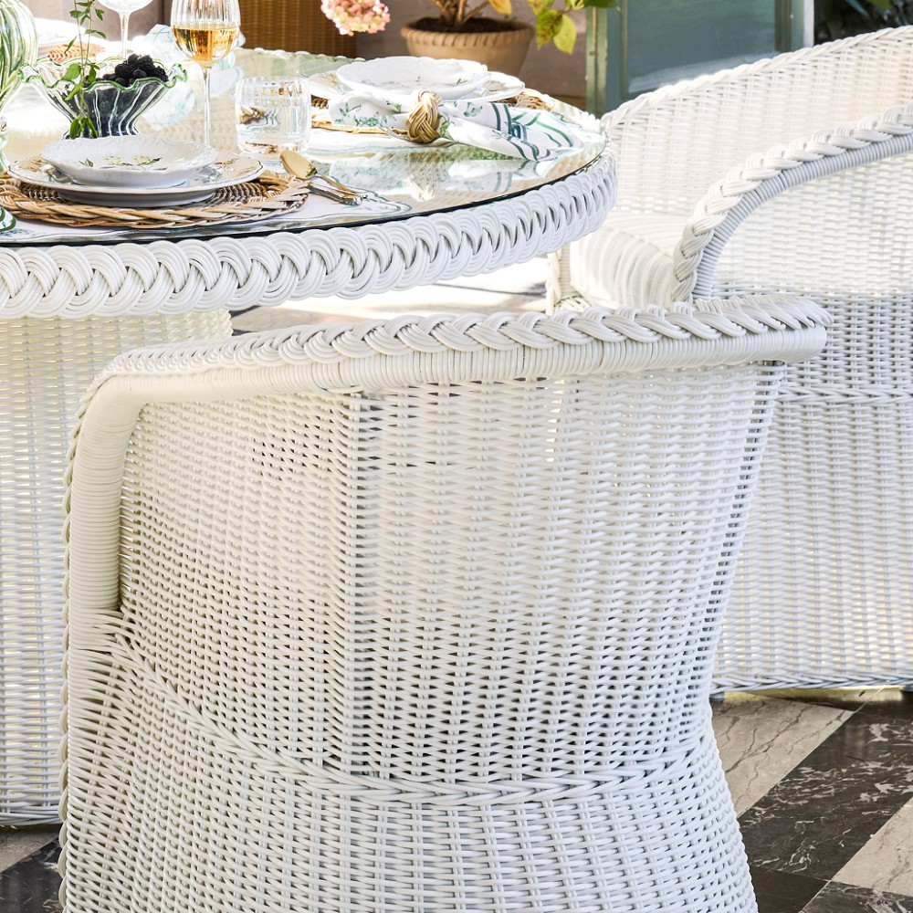 Close-up of white wicker chair back and arm with round edge