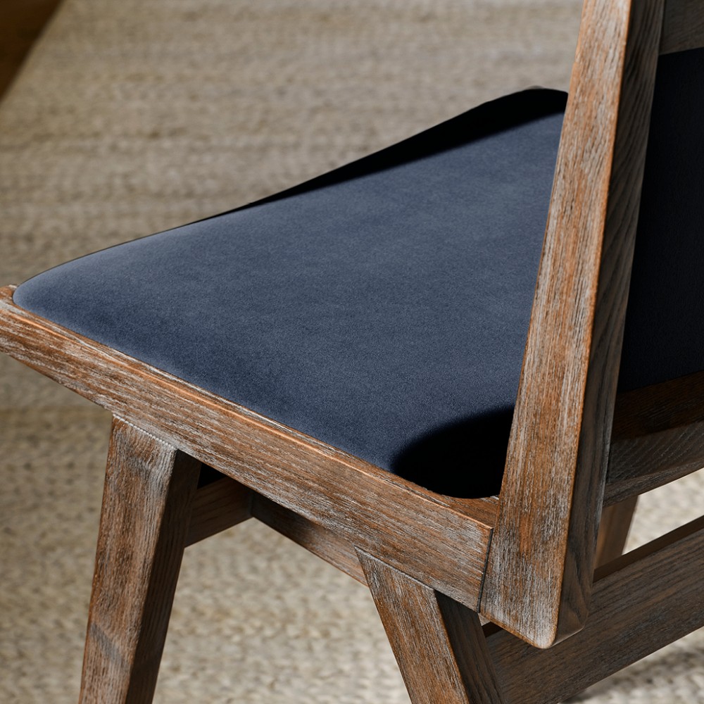 Close-up of navy upholstered chair seat and wooden frame