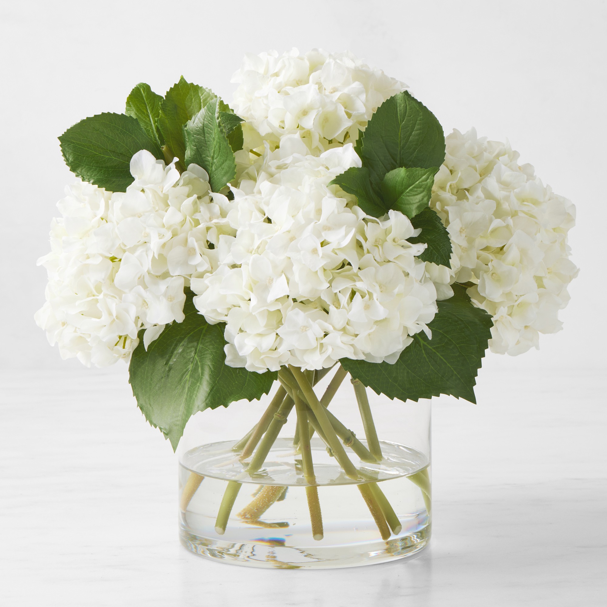 Faux White Hydrangea Arrangement in Glass Vase Simolary simolary.com
