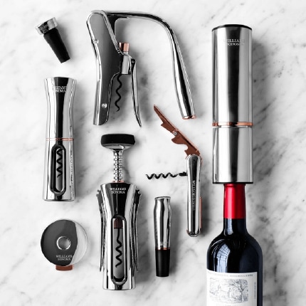 Wine accessories on a counter top including cork screws and bottle plugs.