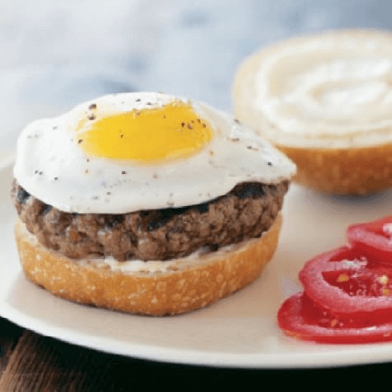 Burger topped with a fried egg on a plate.