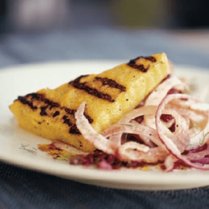 Grilled polenta with fennel salad on a plate.