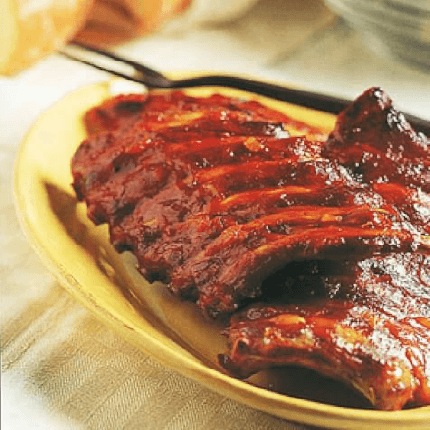 Hickory smoked ribs with georgia mop sauce in a serving dish.