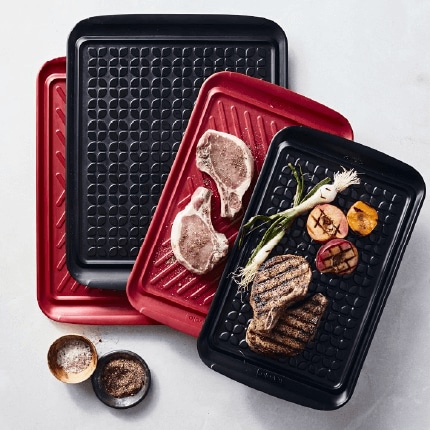 Red and black grill prep trays.