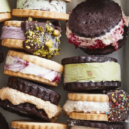 Homemade ice cream sandwiches stacked in a tray.
