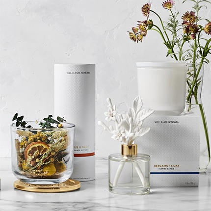 Home Fragrance Jasmine and Yuzu Collection with oils, potpourri, candle diffuser and vase of flowers.