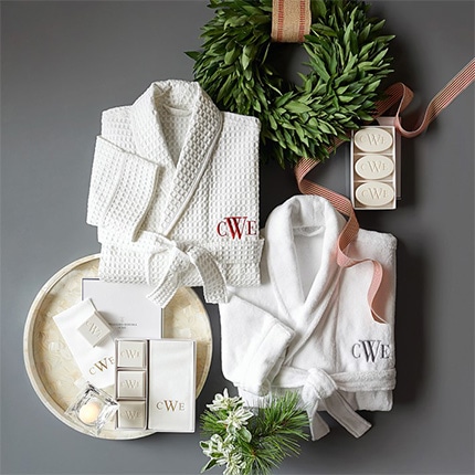 A Monogrammed bathroom set including bathrobes and soaps showing the letters CWE.