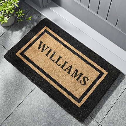 A black and brown personalized double border door mat with the last name Williams printed on it.