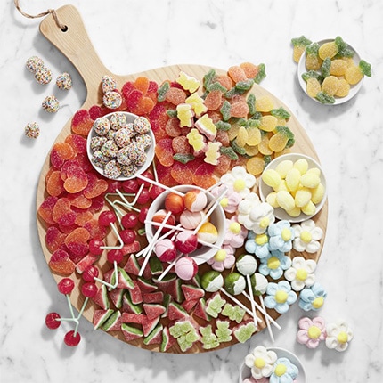 A platter of assorted gourmet candies on top of a white marble counter.