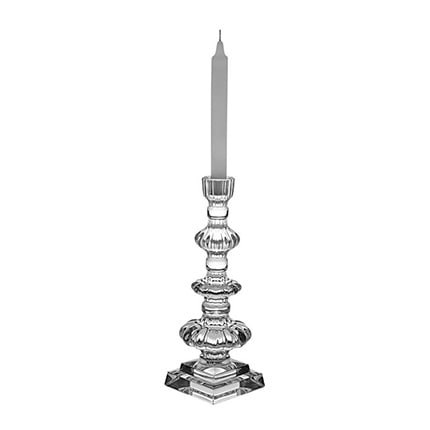 A tiered Vista Alegre Miracle Crystal Candlestick holding a white candle.
