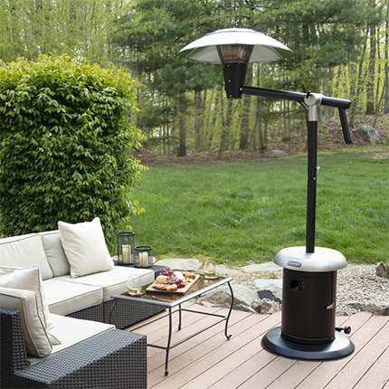 A backyard deck with patio furniture and a Cuisinart Perfect Position adjustable outdoor heater.