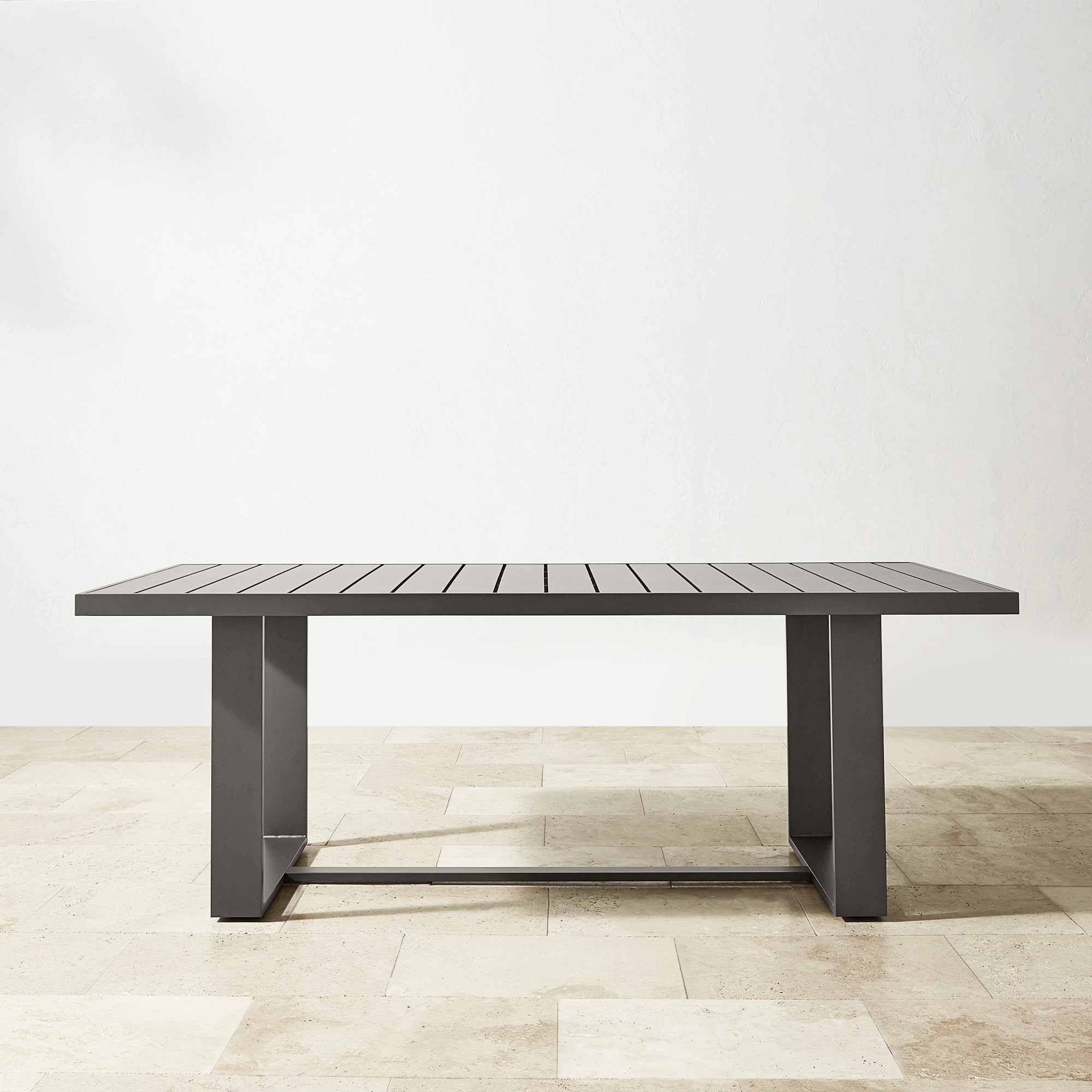 Contemporary armchair with metal frame and mesh fabric seat and back, in dark grey.