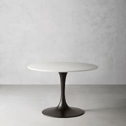 Close-up of a black pedestal base with a wide circular metal foot