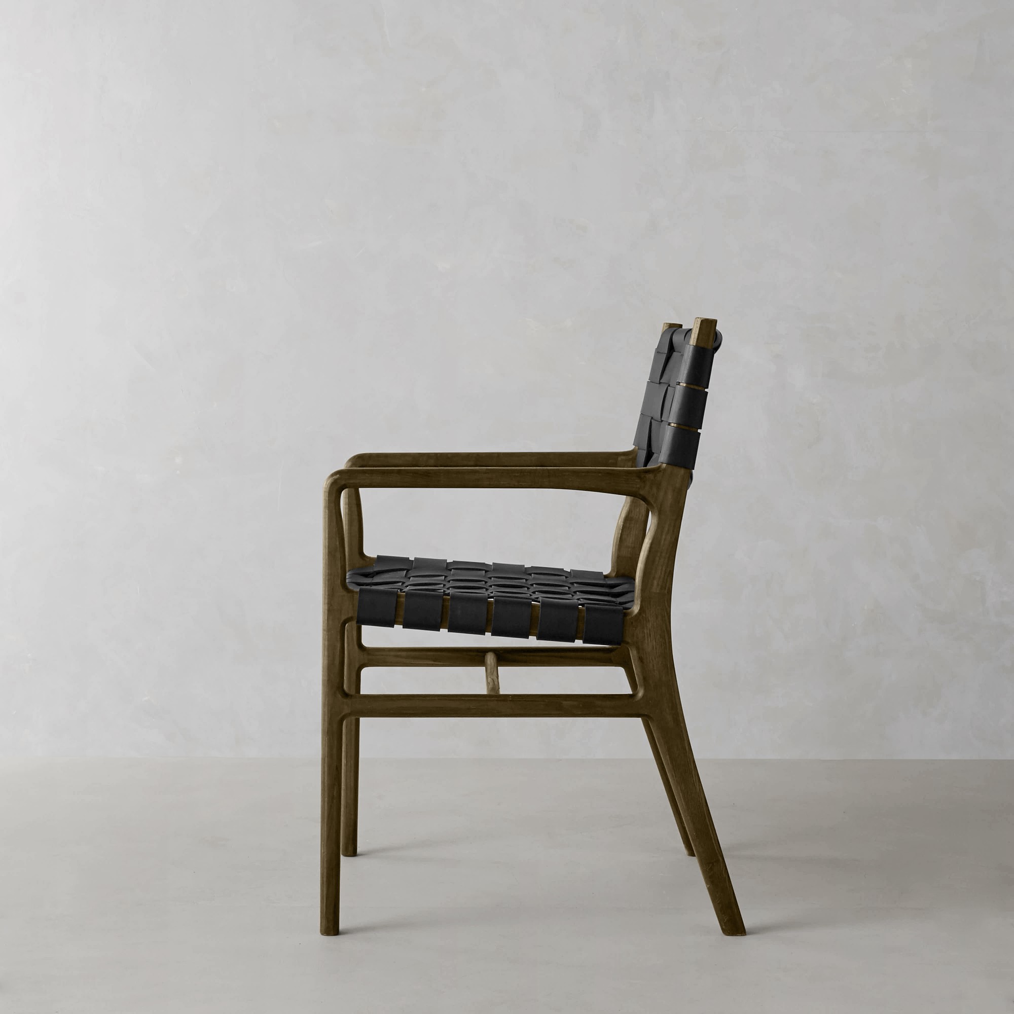 Tan woven leather chair from a different angle, displaying back and side profile.