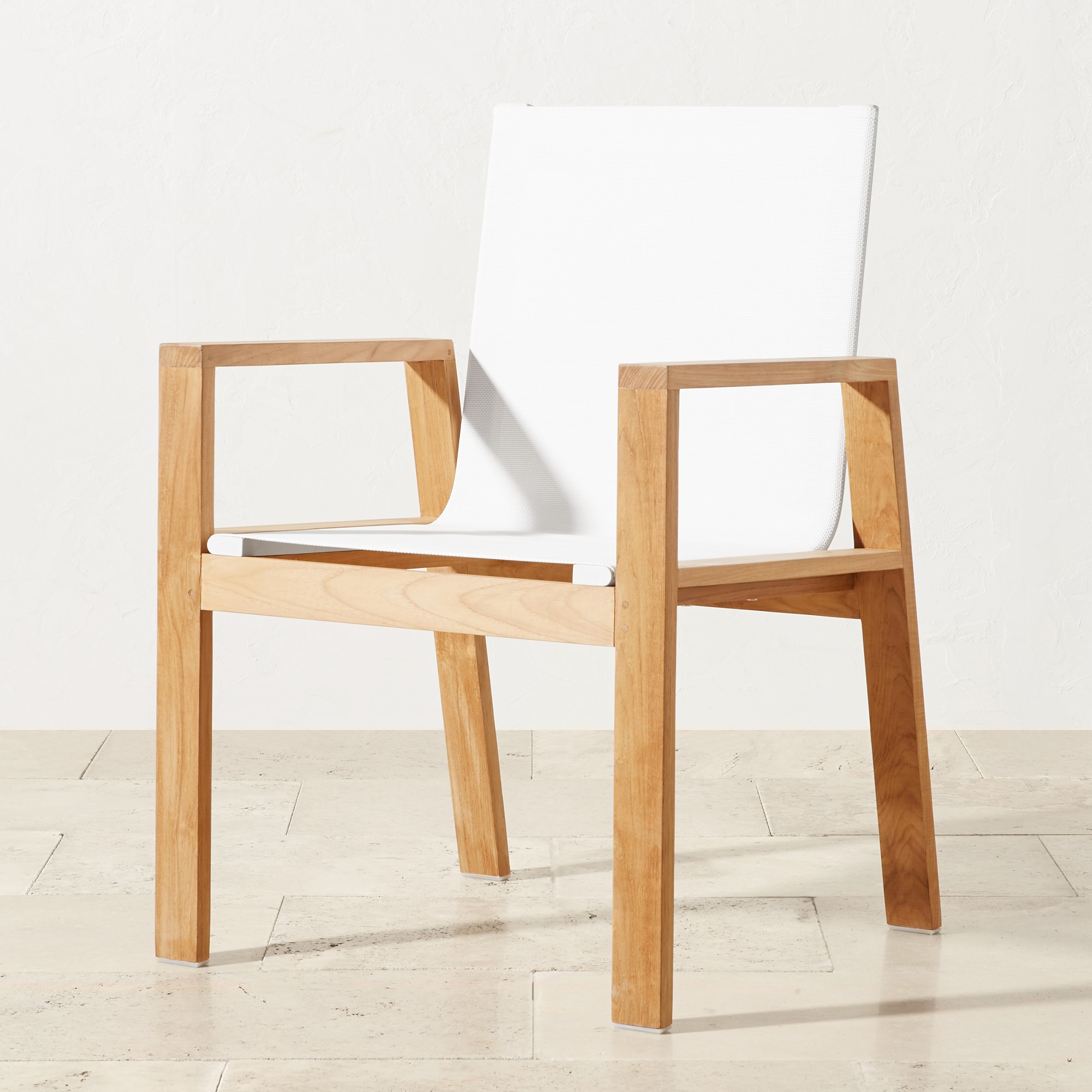 Side view of a white fabric chair with wooden frame