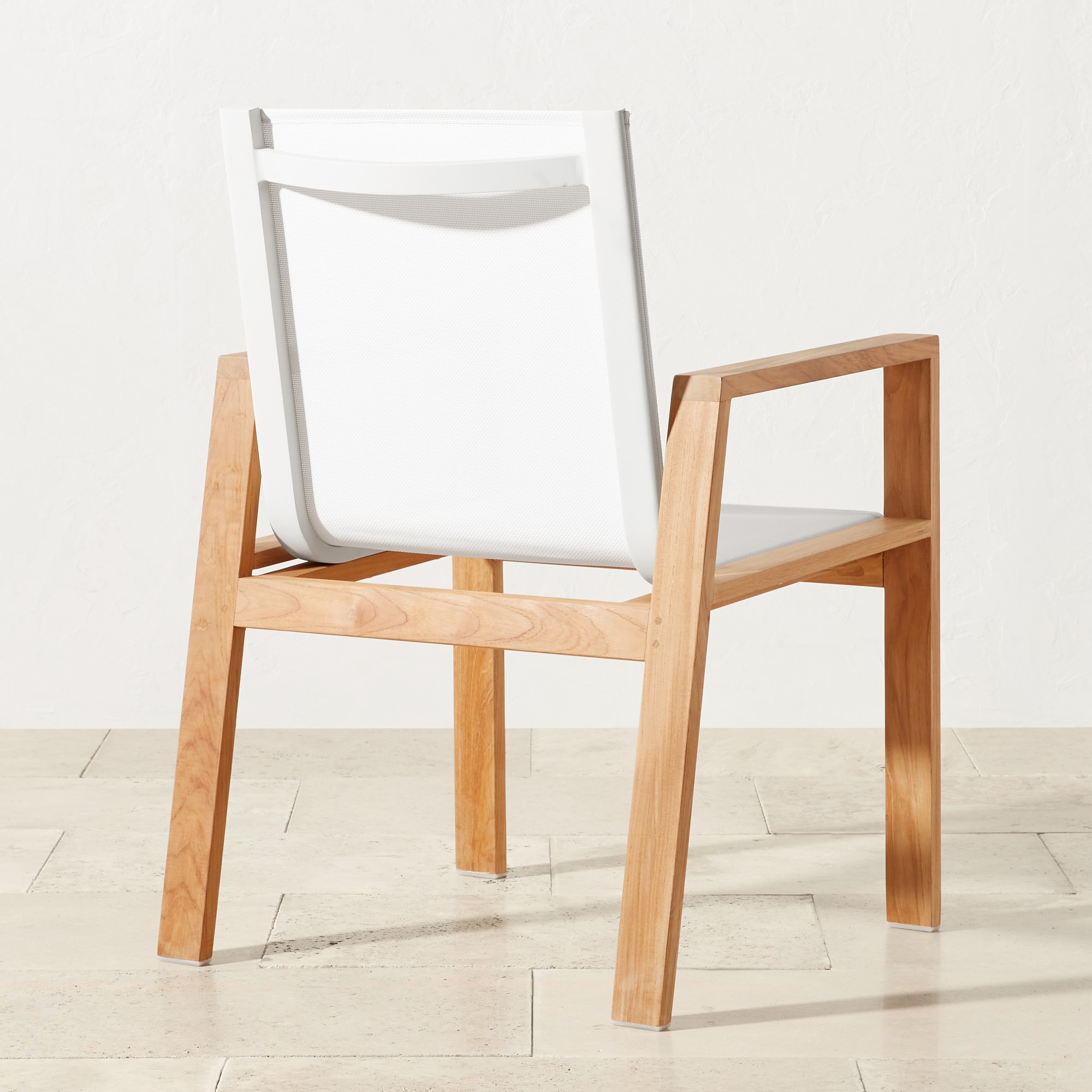 Rear or angled view of white fabric chair on wooden frame