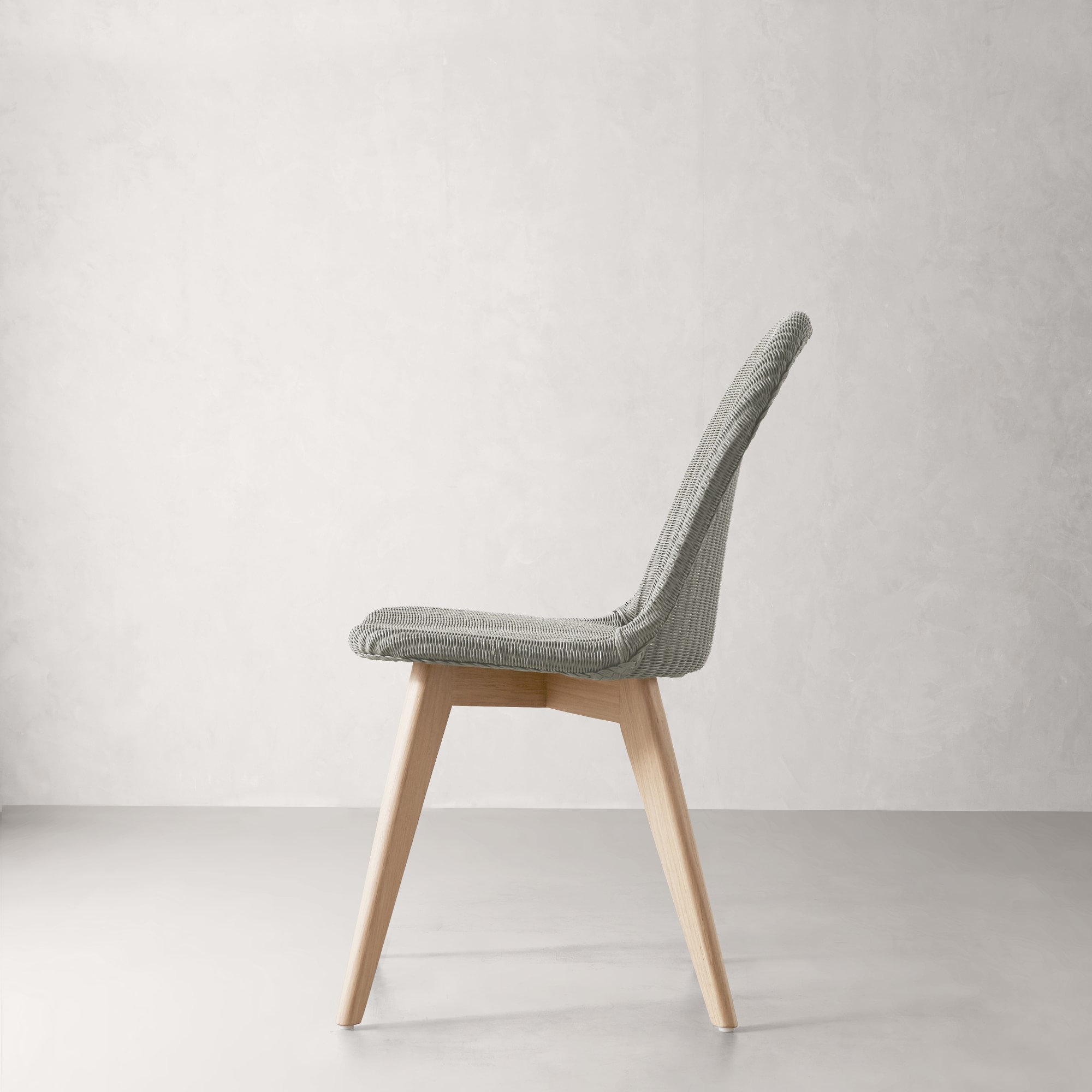 Close-up of the chair seat and weave texture in gray with natural wood legs.