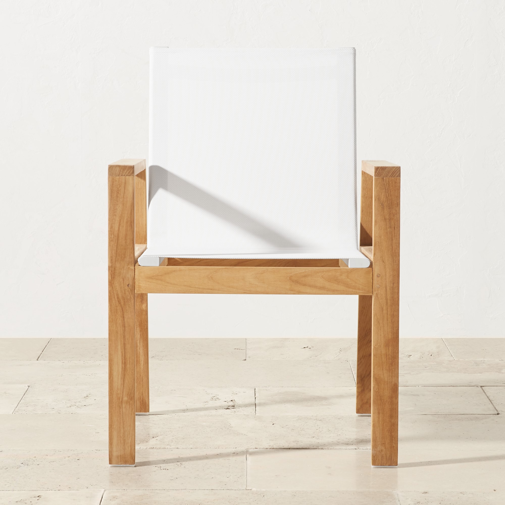 Close-up of a white fabric upholstered chair with wooden frame