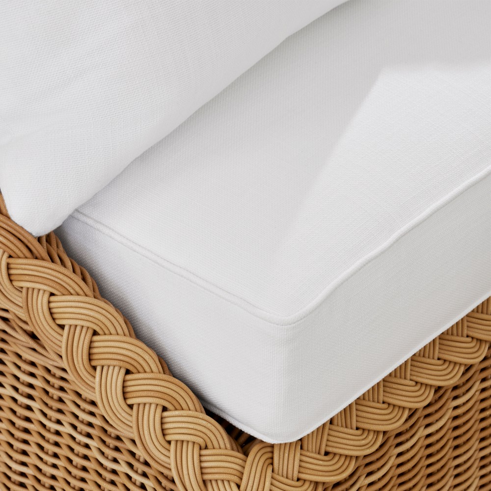 Close-up of white cushion fabric and wicker base