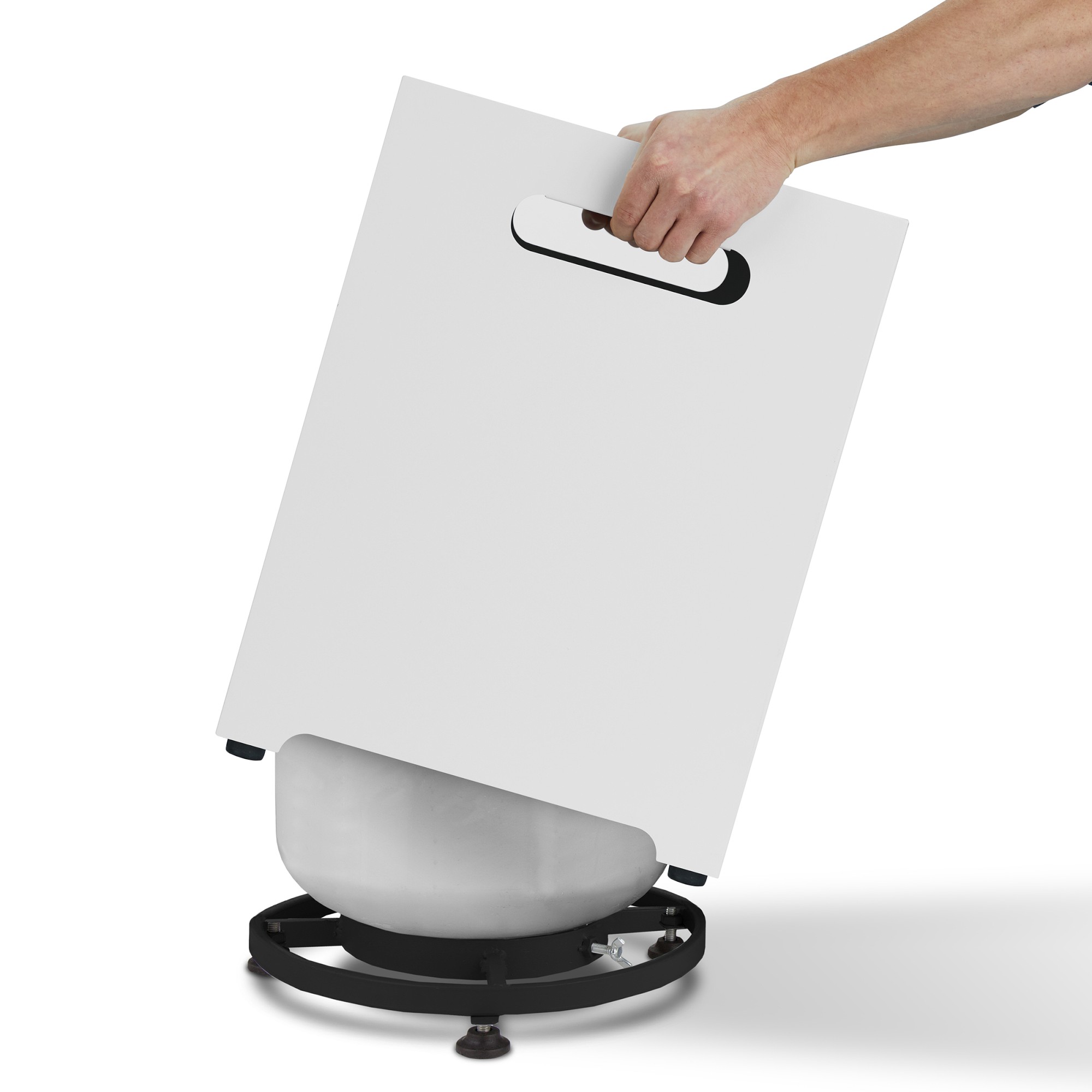 A white version of the storage cube with a built-in handle, being placed onto a round base.