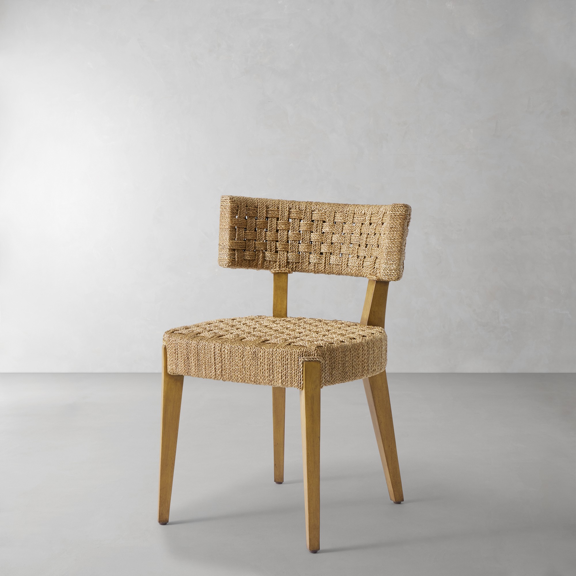 A single woven chair on a plain gray background, showing the chair design.