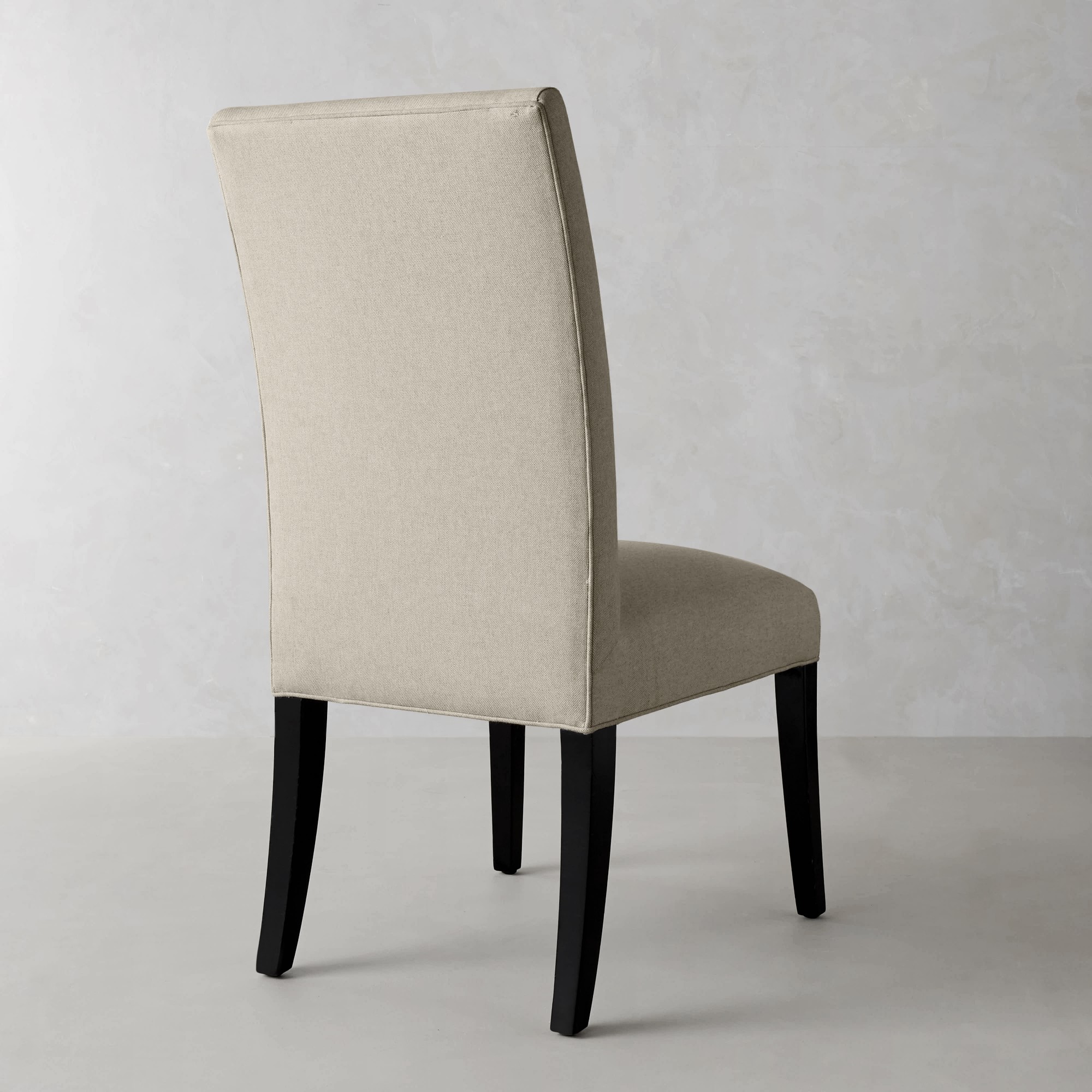 Beige upholstered dining chair back view