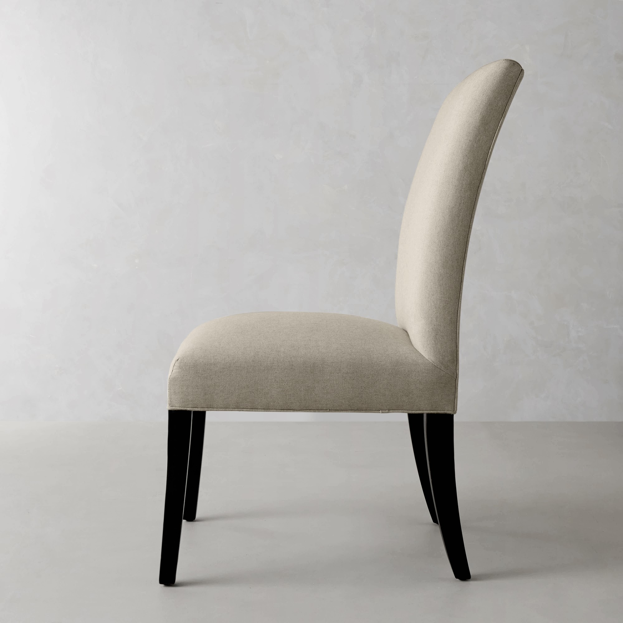 Beige upholstered dining chair side profile back view