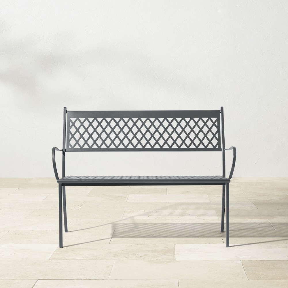 Metal bench with lattice backrest shown on a light tiled floor