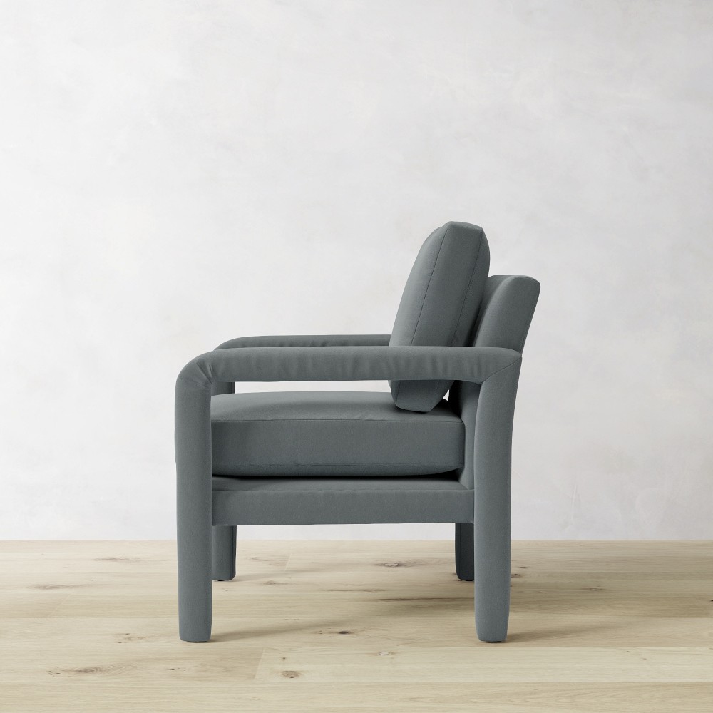 Grey upholstered armchair in profile