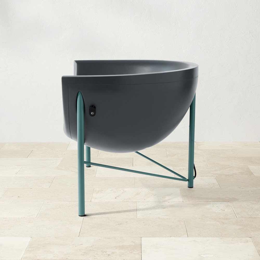 Kosmos chair from side view showing rounded bowl seat and teal legs